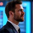 Male CTO in front of server racks, looking thoughtful and innovative